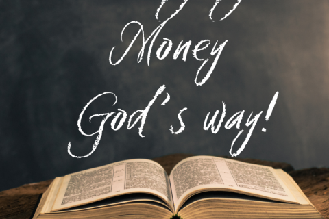 Open Bible on a table with a black background. The words Managing Money God's Way written on the background.